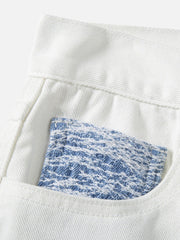 Jean droit déchiré à blocs de couleurs