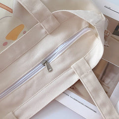 Sac en toile avec chapeau de paille et canard