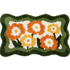Flauschiger Akzentteppich mit orangefarbenen Gänseblümchen